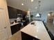Modern kitchen featuring a large island with seating, pendant lighting, and stainless steel appliances at 199 Macaulays Cv, Haines City, FL 33844