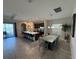 Open-concept kitchen and dining area with a large island, pendant lights, and backyard views at 199 Macaulays Cv, Haines City, FL 33844