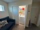 Convenient laundry room with washer, dryer, shelving, and a cozy sitting area at 199 Macaulays Cv, Haines City, FL 33844