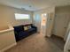 Living area includes a comfortable blue sofa, next to the laundry closet, ideal for relaxation at 199 Macaulays Cv, Haines City, FL 33844