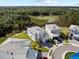This aerial view showcases modern homes in a community, highlighting landscaping, and a serene pond backdrop at 2117 Pine Oak Loop, Davenport, FL 33837