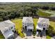 Aerial view of a neighborhood with modern homes, green spaces, and access to wooded areas at 2117 Pine Oak Loop, Davenport, FL 33837