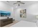 Bright bedroom features modern decor, ceiling fan, wall art, and television at 2117 Pine Oak Loop, Davenport, FL 33837
