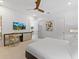 Well-lit primary bedroom featuring a ceiling fan, desk and a decorative abstract art piece at 2117 Pine Oak Loop, Davenport, FL 33837