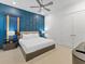 Stunning bedroom showcases a luxurious bed and unique blue accent wall at 2117 Pine Oak Loop, Davenport, FL 33837