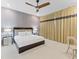 Luxurious bedroom with a decorative wall, ceiling fan, and gold curtains and lamps at 2117 Pine Oak Loop, Davenport, FL 33837