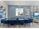Elegant dining area featuring a large table with blue seating, a decorative light fixture, and art at 2117 Pine Oak Loop, Davenport, FL 33837