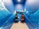 Unique game room featuring wave murals and two gaming chairs at 2117 Pine Oak Loop, Davenport, FL 33837