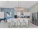 Modern kitchen featuring a large kitchen island with bar stool seating and stainless steel appliances at 2117 Pine Oak Loop, Davenport, FL 33837