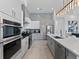 Bright kitchen with modern stainless steel appliances, a sleek design, and adjacent dining area at 2117 Pine Oak Loop, Davenport, FL 33837