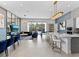 A well lit living room with a kitchen, dining area, and a billiard table, perfect for entertaining at 2117 Pine Oak Loop, Davenport, FL 33837