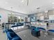 A well lit living room with a kitchen, dining area, and a billiard table, perfect for entertaining at 2117 Pine Oak Loop, Davenport, FL 33837