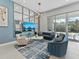 Living room with a cozy seating arrangement, modern decor, large mirror and view of the pool at 2117 Pine Oak Loop, Davenport, FL 33837