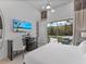 Bright and airy bedroom features desk and sliding glass doors to a screened pool at 2117 Pine Oak Loop, Davenport, FL 33837