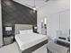 Beautiful main bedroom with unique black accent wall and ensuite bathroom at 2117 Pine Oak Loop, Davenport, FL 33837