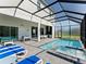 Beautiful pool and spa alongside an outdoor kitchen and entertaining space at 2117 Pine Oak Loop, Davenport, FL 33837