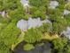 View of the condominium with mature trees, parking, and pond at 2210 Yankee Pl # 334, Orlando, FL 32839