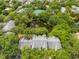 Overhead view of complex, including tennis courts, a pond with fountain, and verdant trees at 2210 Yankee Pl # 334, Orlando, FL 32839
