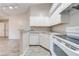 Clean kitchen featuring white cabinets and appliances and a breakfast bar at 2210 Yankee Pl # 334, Orlando, FL 32839
