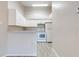 Bright kitchen with all white cabinets and appliances, with vaulted ceiling at 2210 Yankee Pl # 334, Orlando, FL 32839