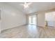 Open concept living room with wood floors, sliding glass doors to balcony, and washer/dryer at 2210 Yankee Pl # 334, Orlando, FL 32839