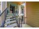 View of the stairwell with black metal railings, and multiple condo entrances at 2210 Yankee Pl # 334, Orlando, FL 32839