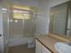 Bathroom featuring a shower-tub combo, toilet, large mirror, and vanity with a sink at 2235 Emperor Dr, Kissimmee, FL 34744