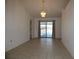 Open dining room with tile floors features a hanging light fixture and sliding glass doors to the lanai at 2235 Emperor Dr, Kissimmee, FL 34744