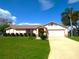 Charming single-story home features a well-maintained lawn and attached two-car garage at 2235 Emperor Dr, Kissimmee, FL 34744