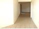 Hallway featuring neutral tile flooring, white walls and several entryways at 2235 Emperor Dr, Kissimmee, FL 34744