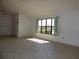 Bright living room with a vaulted ceiling, window and tile floor throughout at 2235 Emperor Dr, Kissimmee, FL 34744
