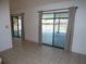 Bright living room with tile flooring and sliding glass doors offering views of the screened-in lanai at 2235 Emperor Dr, Kissimmee, FL 34744