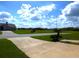 Landscaped street view in a quiet residential neighborhood with a paved driveway and sidewalks at 2235 Emperor Dr, Kissimmee, FL 34744