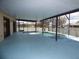 Enclosed pool area with blue deck, screened enclosure, and view of surrounding neighborhood at 2235 Emperor Dr, Kissimmee, FL 34744