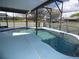 A close-up view of the enclosed pool with clear water and tile details at 2235 Emperor Dr, Kissimmee, FL 34744