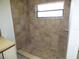 Tiled walk-in shower includes a large window and seat at 2235 Emperor Dr, Kissimmee, FL 34744