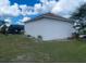 Exterior home view showcasing a well-maintained backyard and screened-in pool area with lush landscaping at 24 Cordona Dr, Kissimmee, FL 34758