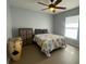Comfortable bedroom with a ceiling fan, a window for natural light, and storage options at 24 Cordona Dr, Kissimmee, FL 34758