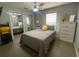Cozy bedroom featuring mirrored closet doors, a large window, and a dresser with decorative plants at 24 Cordona Dr, Kissimmee, FL 34758
