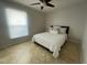 Bright bedroom features a queen-sized bed with a white comforter and a window for natural light at 24 Cordona Dr, Kissimmee, FL 34758
