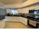The kitchen is equipped with stainless steel appliances, granite countertops, and white cabinetry at 24 Cordona Dr, Kissimmee, FL 34758