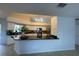 Modern kitchen boasts white cabinets, stainless appliances, and a black countertop bar for casual dining at 24 Cordona Dr, Kissimmee, FL 34758