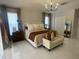 Serene main bedroom with a plush bed, modern chandelier, and neutral decor for a relaxing retreat at 24 Cordona Dr, Kissimmee, FL 34758