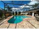 Beautiful backyard pool with a screened enclosure, stylish lighting, and well-maintained landscaping at 24 Cordona Dr, Kissimmee, FL 34758