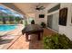 Screened-in pool patio featuring a pool table, exterior fan, flat screen TV, and sliding doors at 24 Cordona Dr, Kissimmee, FL 34758