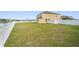 Large, green backyard with a white picket fence, ideal for entertaining or relaxing outdoors at 2412 Country Pond Ct, St Cloud, FL 34771