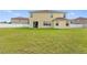 Large, level backyard with a white picket fence, offering ample space for recreation and relaxation at 2412 Country Pond Ct, St Cloud, FL 34771