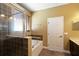 Bathroom featuring tile flooring, a tub, and a tiled glass enclosed shower at 2412 Country Pond Ct, St Cloud, FL 34771