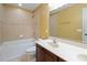 Well-lit bathroom featuring tile flooring, a tub, and a vanity with sink at 2412 Country Pond Ct, St Cloud, FL 34771