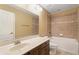 Bathroom with a modern vanity, tile surround bath, and framed mirror at 2412 Country Pond Ct, St Cloud, FL 34771